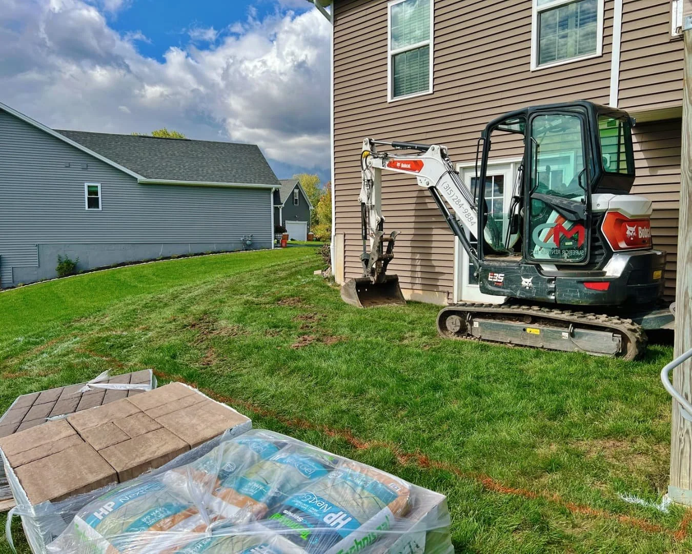 Paver material staging area for a Pines and Pavers project in Lysander, New York.