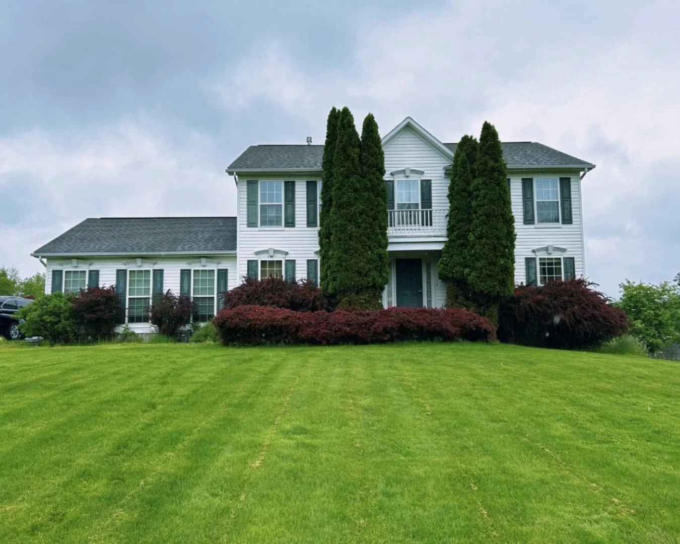 Curved paver border walkway at a Central New York home with clean edging and a finished lawn transition.