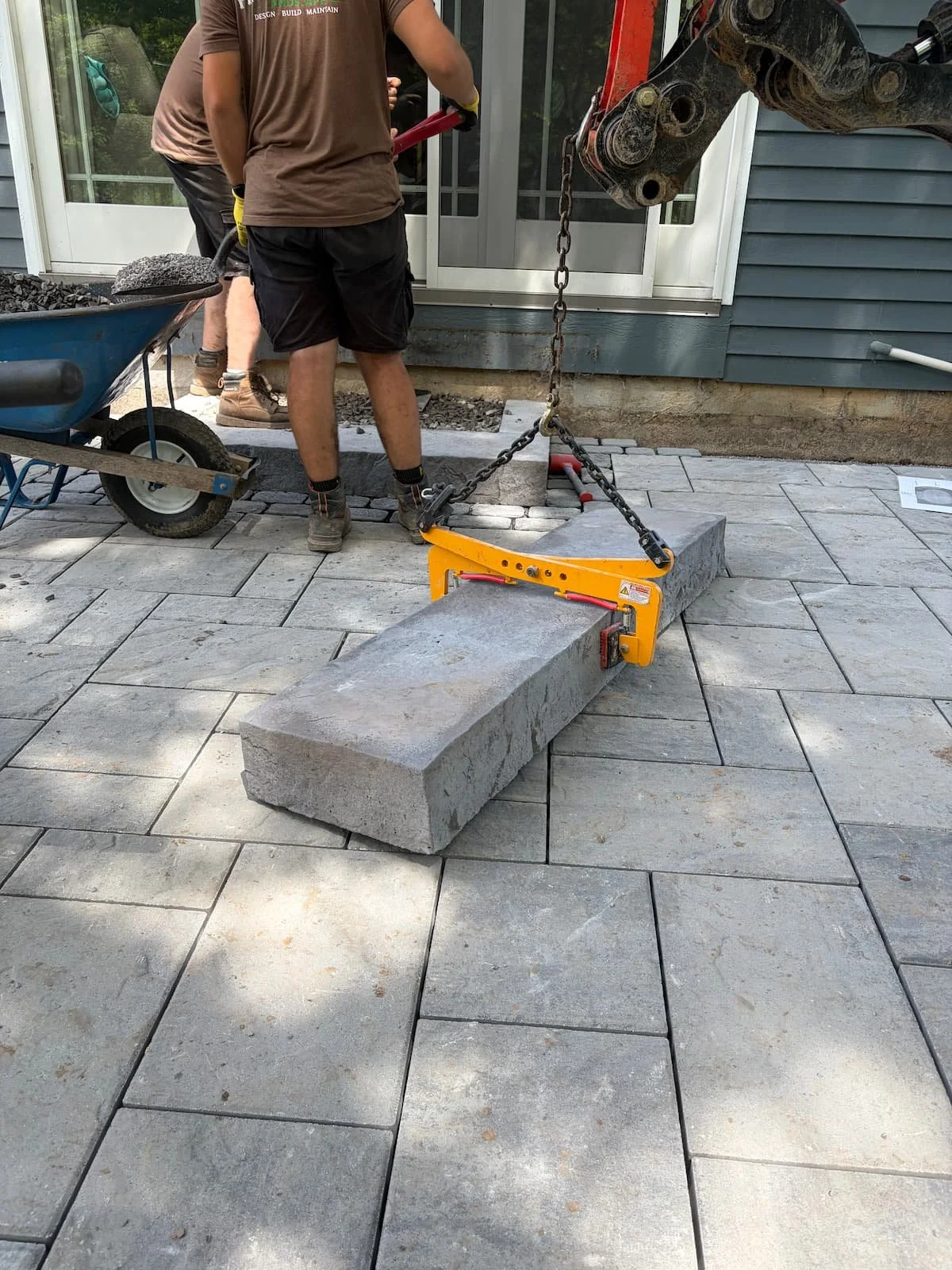 Hardscape crew completing paver patio construction and steps at a Central New York home.