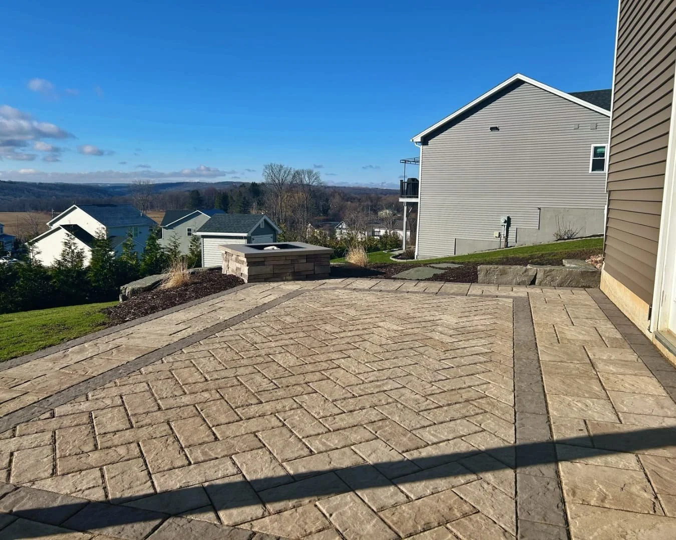 Paver pad and border installation by Pines and Pavers in Lysander, New York.