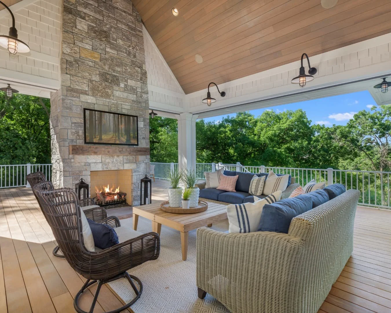 Outdoor fireplace inspiration with a bright covered lounge area centered around a fireplace wall.