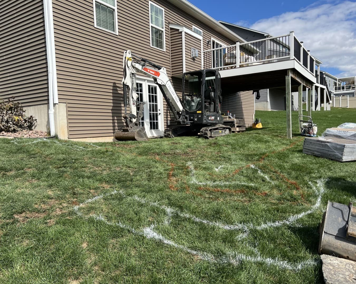 Paver landing and walkway detail beside a home at a Baldwinsville, NY hardscape installation.