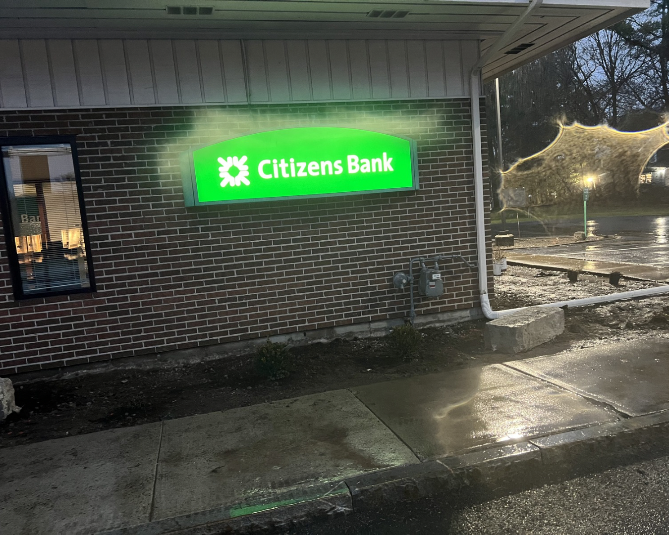 Parking lot landscape bed at an Upstate New York commercial property with fresh mulch and newly maintained planting areas.