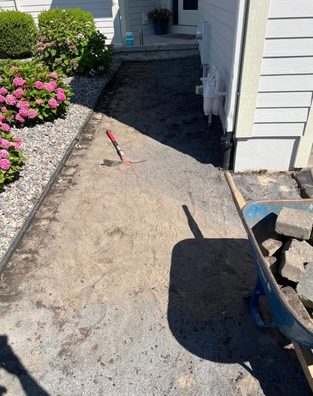 Front entry paver walkway at a Fayetteville, NY home with warm-toned stone and clean hardscape edging.