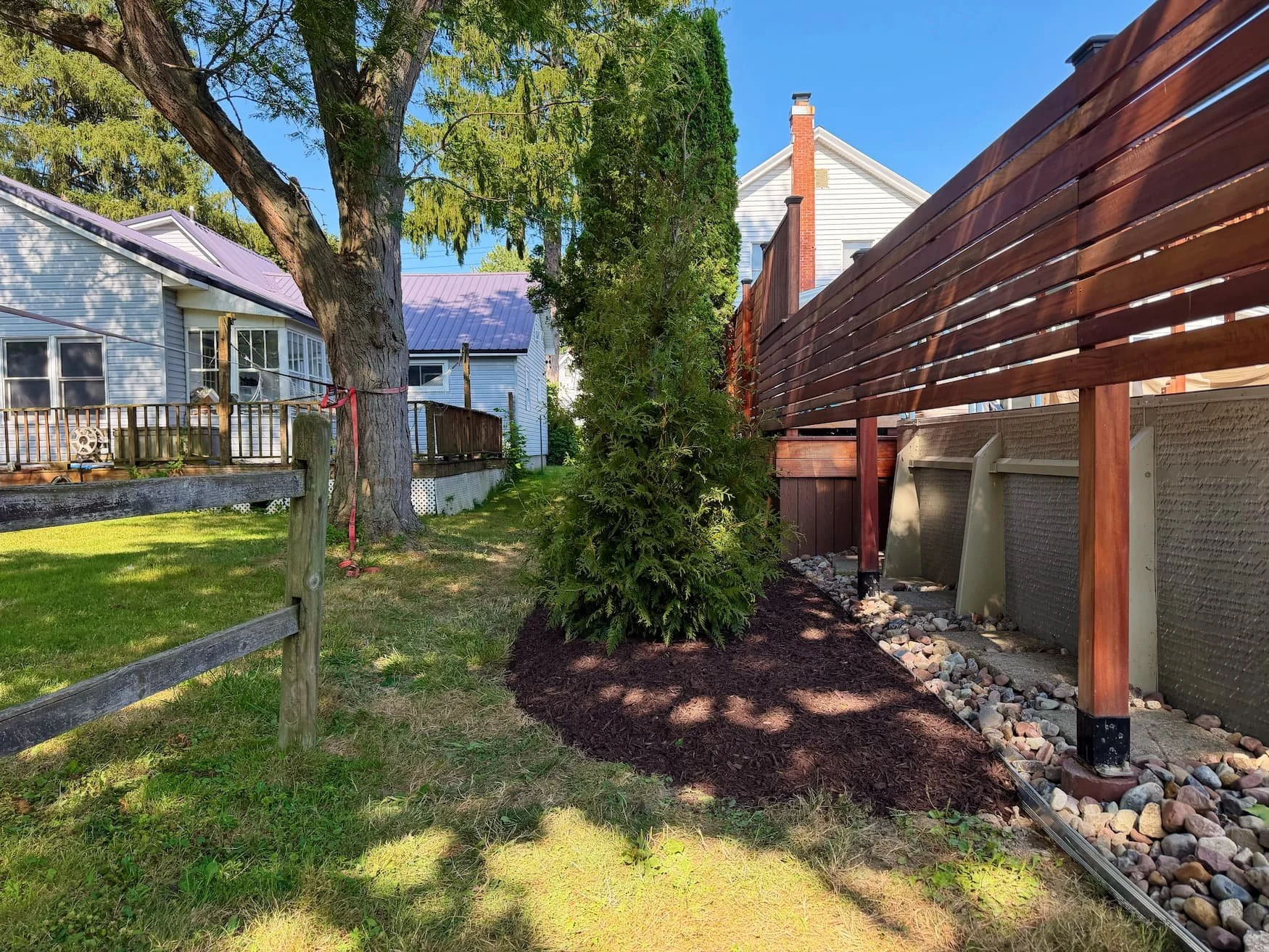 Finished paver patio and freshly renovated lawn area in a Central New York backyard.