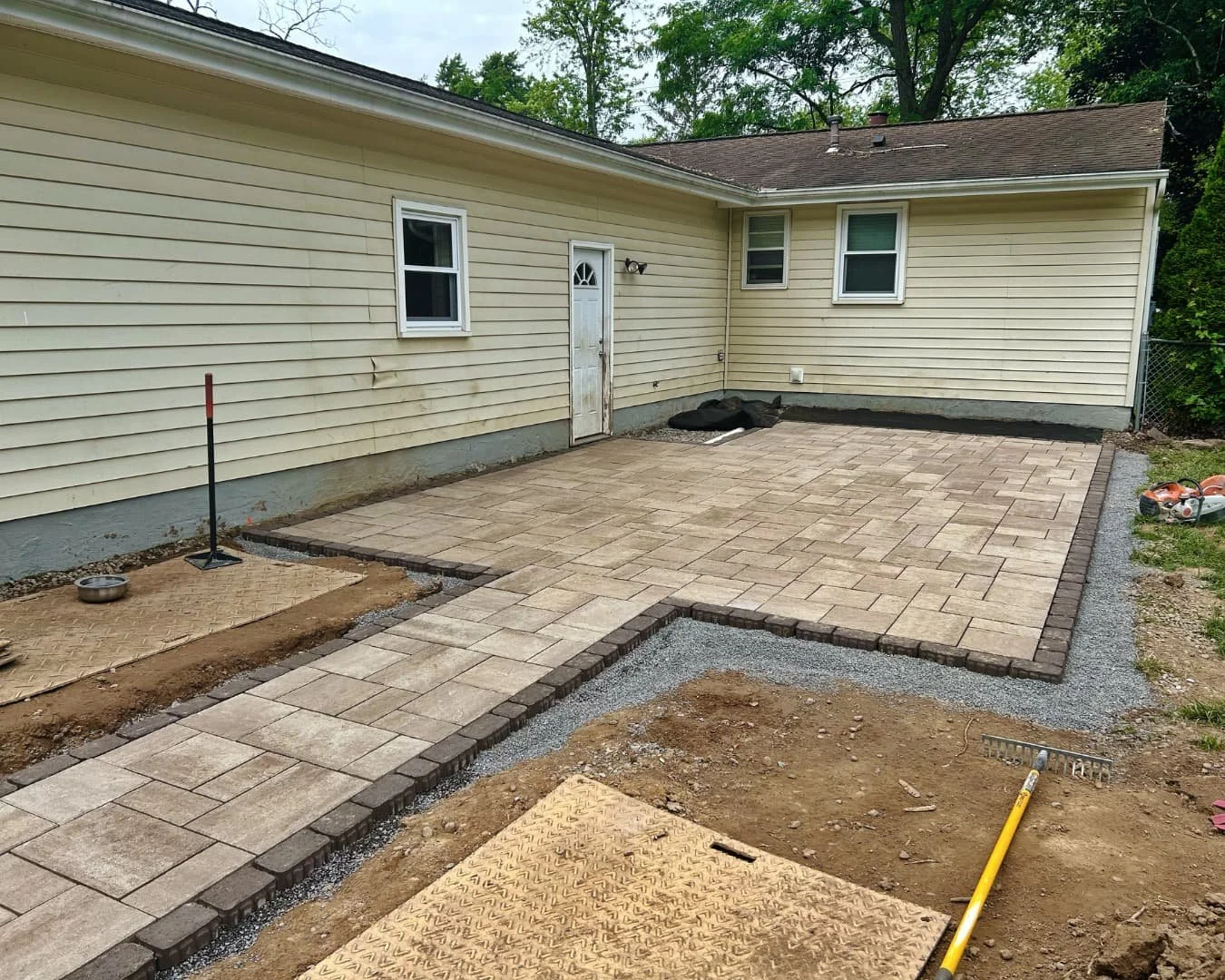 Paver patio installation in progress by Pines and Pavers in Central New York.