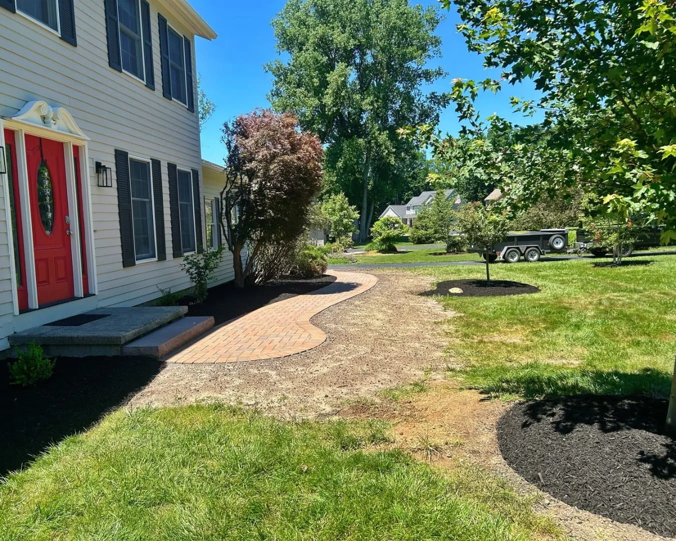 Front entry walkway by the red door completed by Pines and Pavers in Manlius, New York.