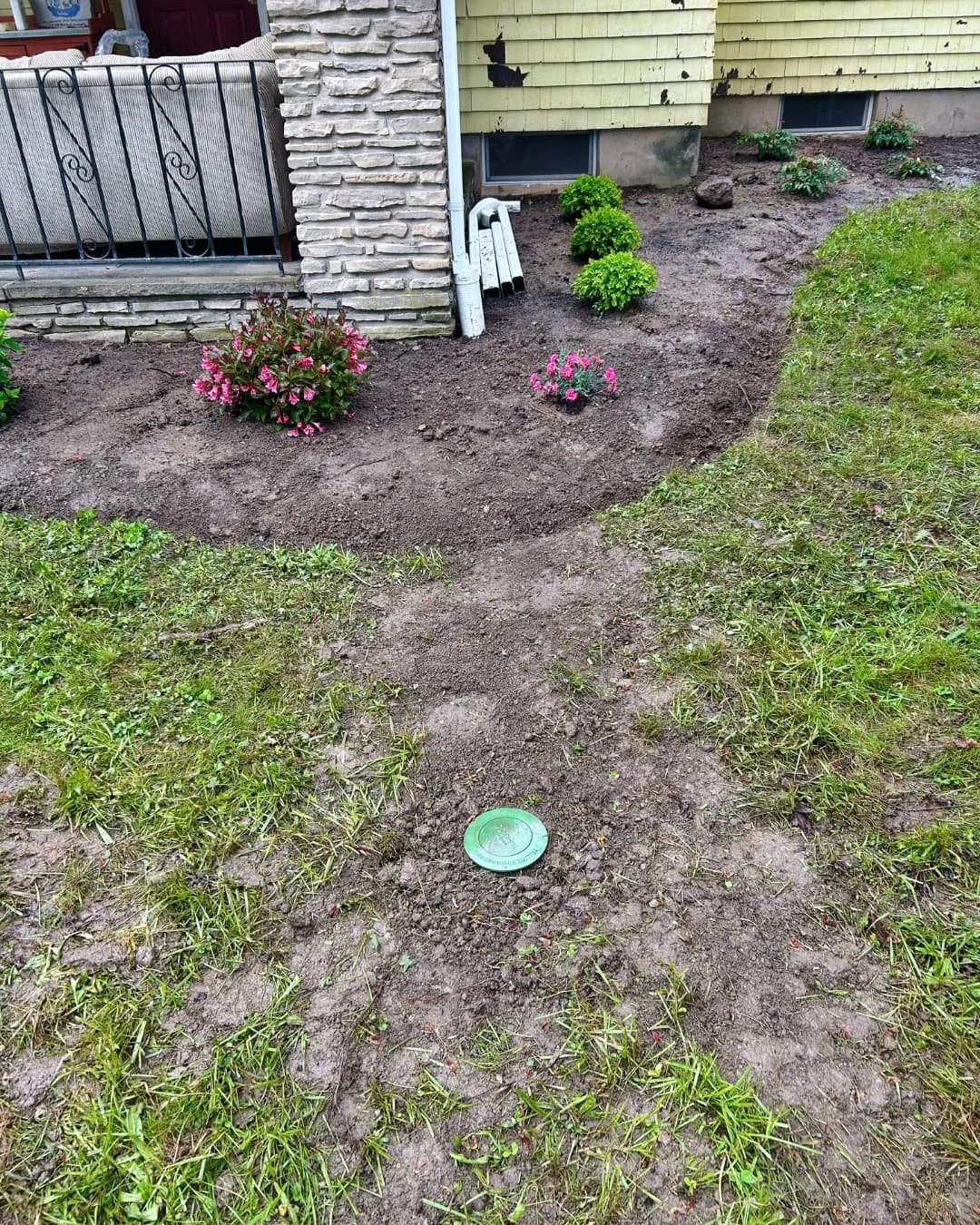 Front entry yard before hardscape installation by Pines and Pavers at a Central New York home.