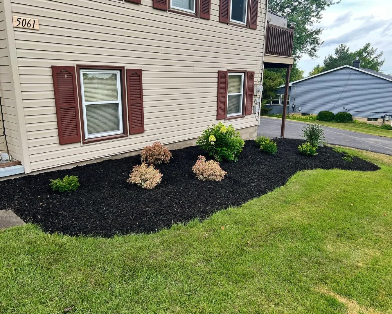 Foundation planting bed beside the home completed by Pines and Pavers in Upstate New York.