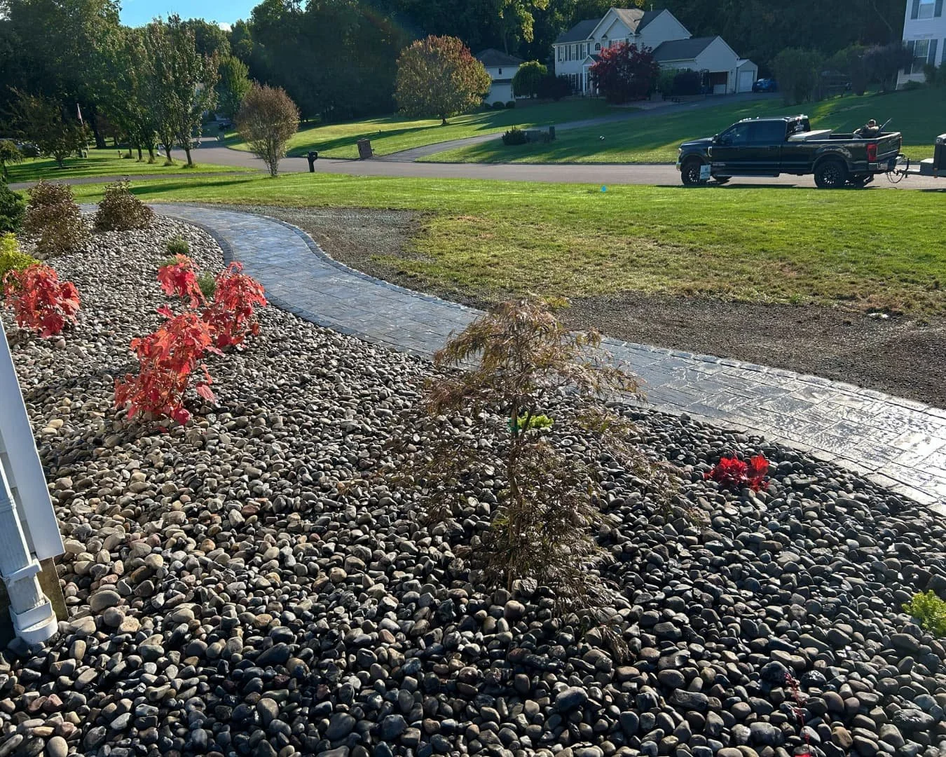 Front walkway curve and landscape border completed by Pines and Pavers in Baldwinsville, New York.