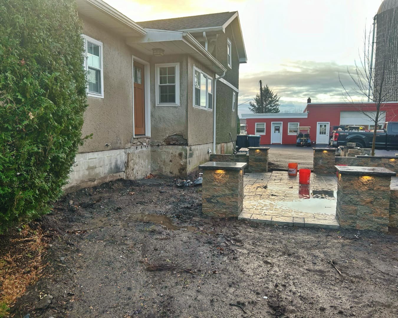 Existing shrubs and side yard before installation by Pines and Pavers in Fayetteville, New York.