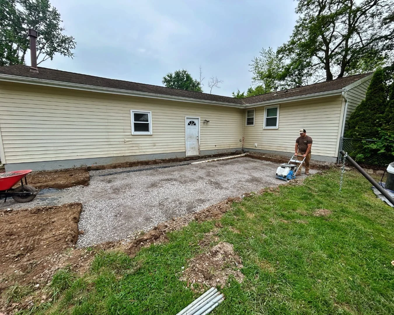 Backyard site preparation during the hardscape project by Pines and Pavers in Central New York.