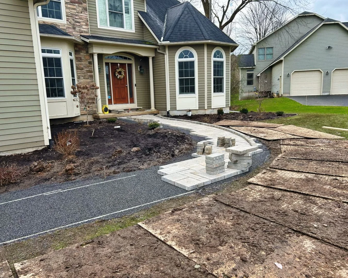Paver entry walkway and river rock border by Pines and Pavers in Fayetteville, New York.