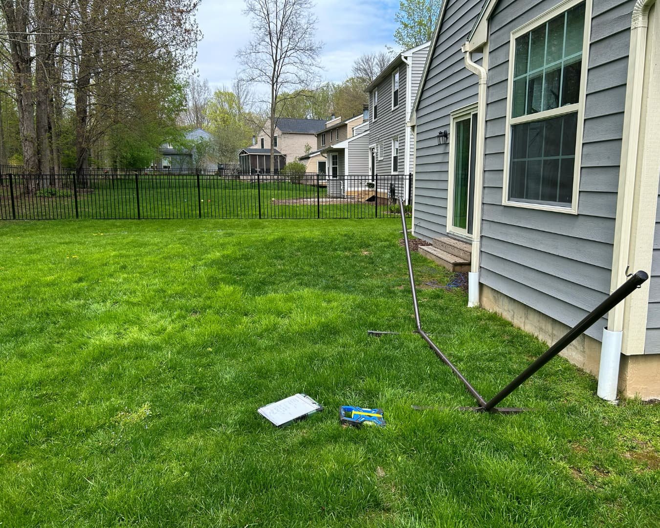 Rear side yard before hardscape installation by Pines and Pavers in Brewerton, New York.