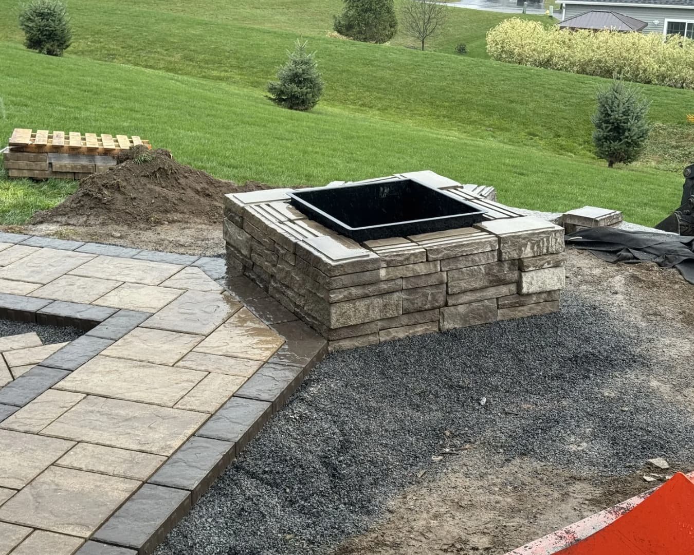 Circular landscape bed design with decorative edging and lawn detail at a Baldwinsville, NY residence.