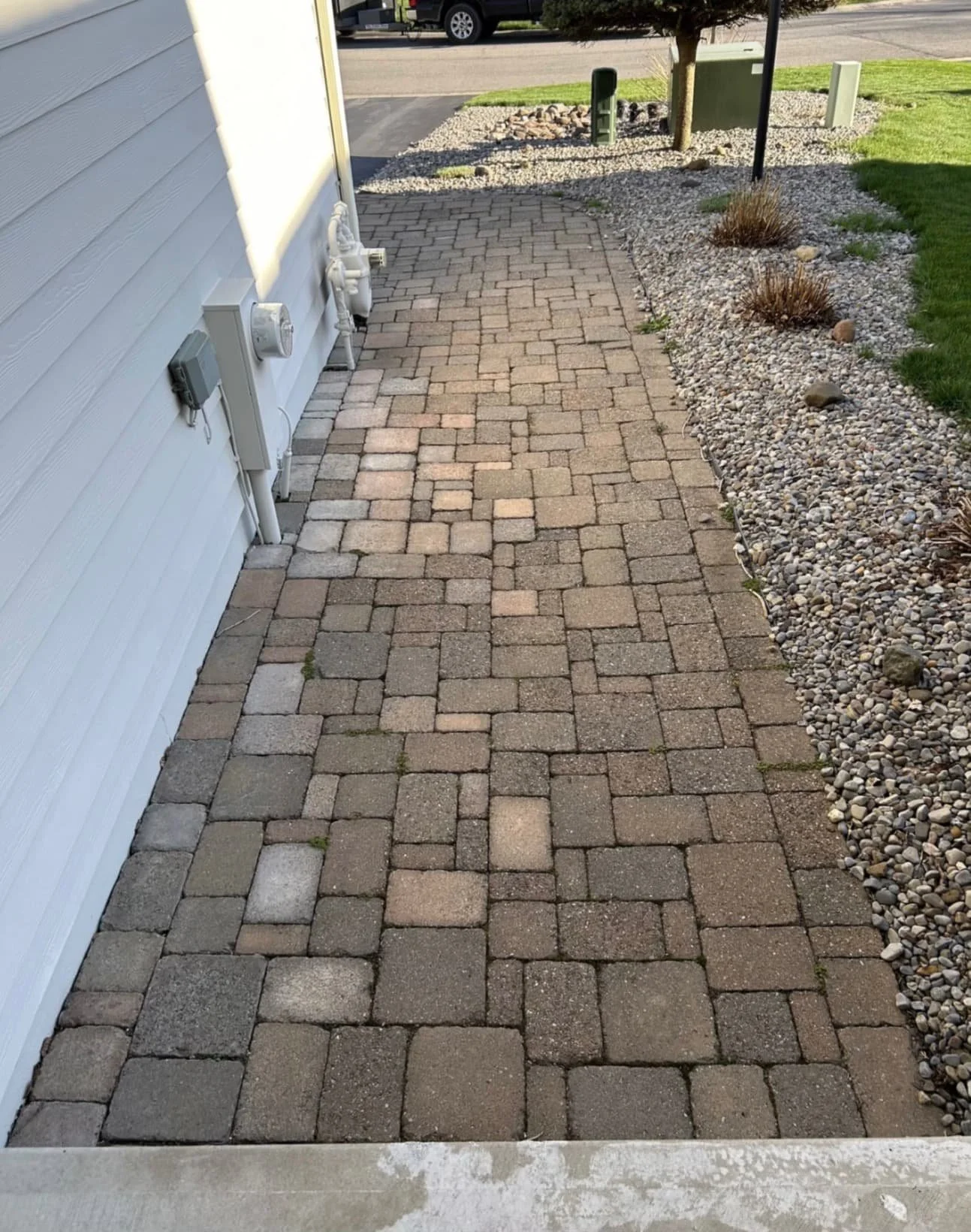 Cobblestone-style side walkway completed by Pines and Pavers in Central New York.