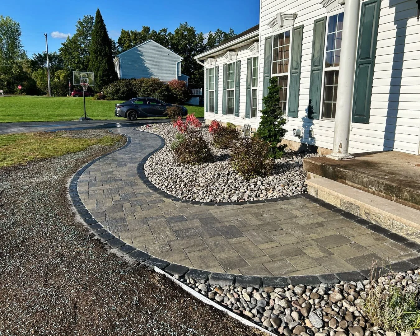 Curved front entry walkway completed by Pines and Pavers in Baldwinsville, New York.