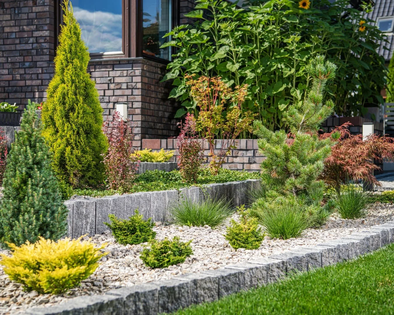 Layered landscaping inspiration featuring steps, low landscape lighting, and layered planting for depth and texture.