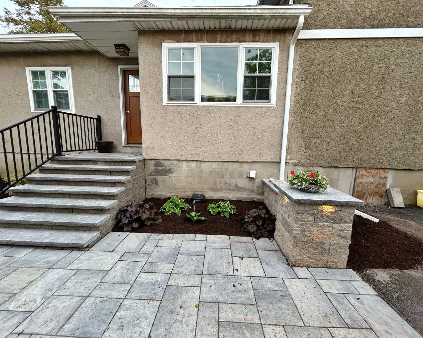 Front yard landscape installation beside the home completed by Pines and Pavers in Fayetteville, New York.