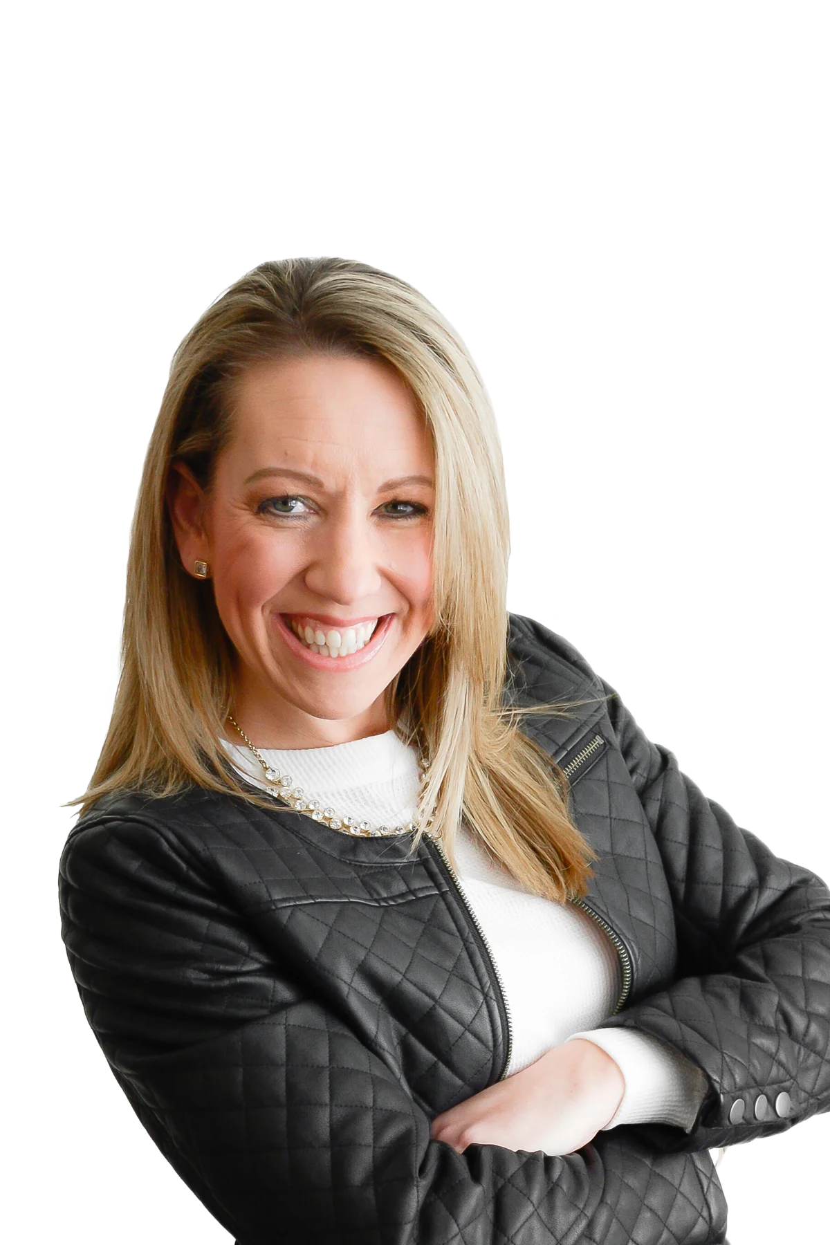 A woman with blonde hair smiling with arms crossed, wearing a black quilted jacket and a white top behind a graphic background.