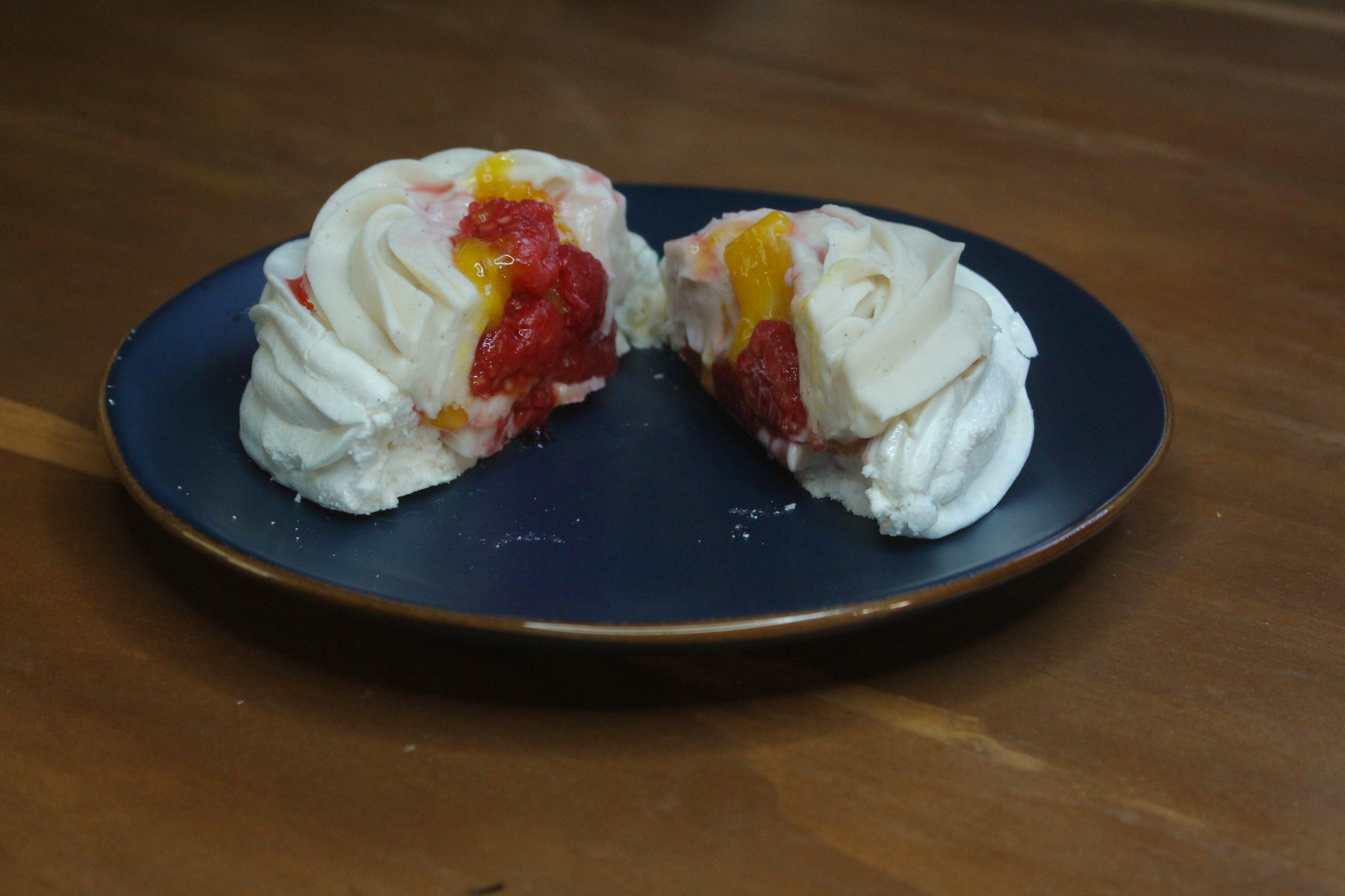 Pavlova cut in half to show the Raspberry and Cream filling