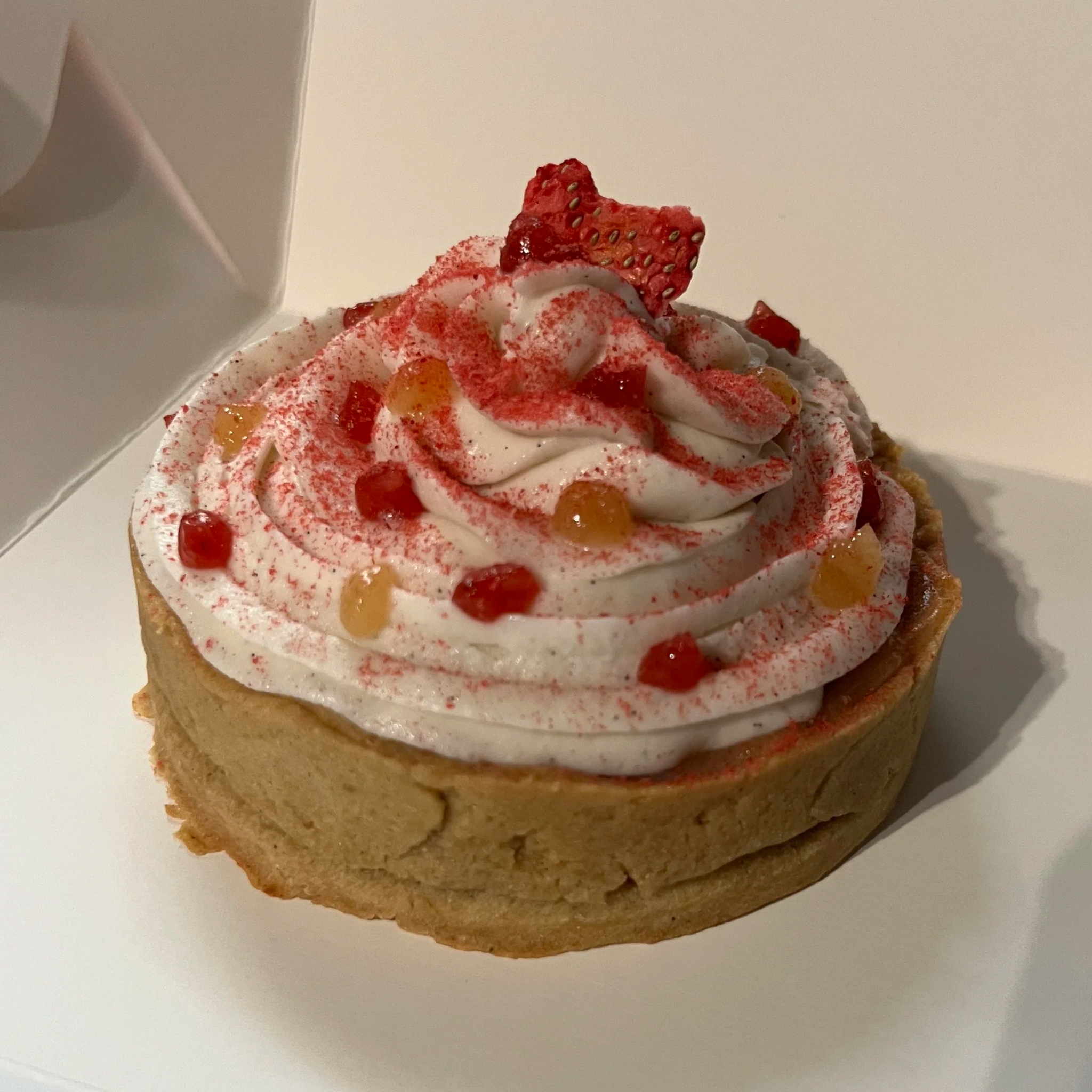 Circular Tart topped with Whipped Cream and dots of Fruity Gel