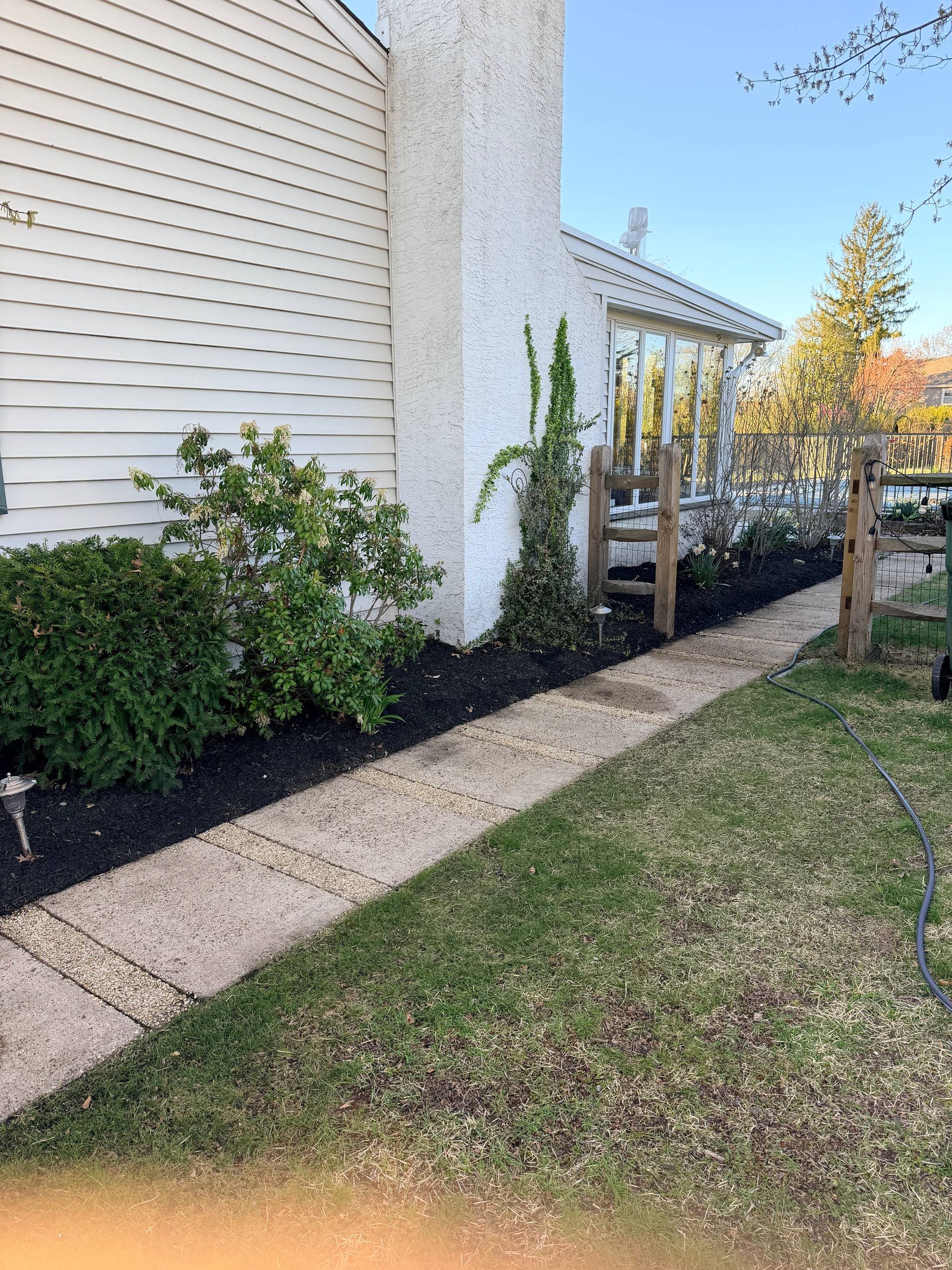Side walkway after power washing in Bucks County PA with clean concrete and improved appearance