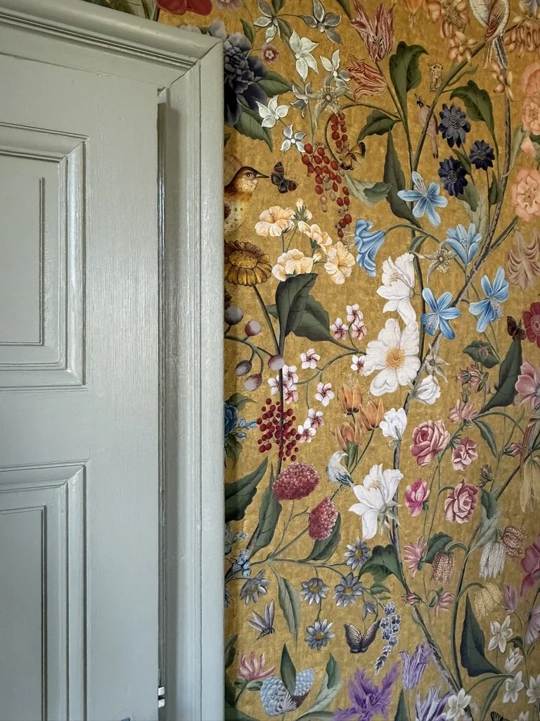 Detail of traditional paintwork and floral wallpaper