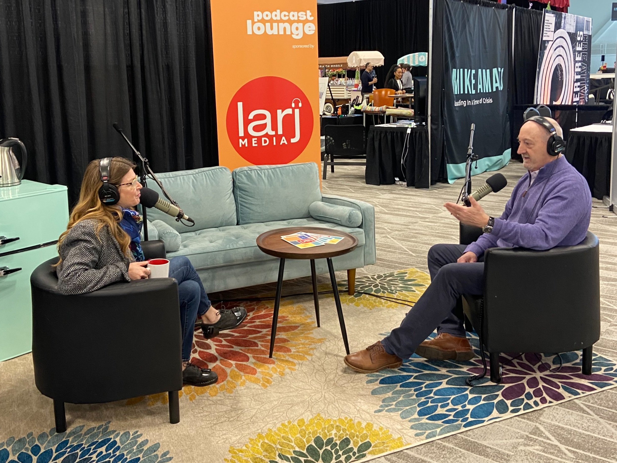 Tina Nole conducts an interview on the makeshift living room set or "podcast lounge" at the Northwest Events Show.