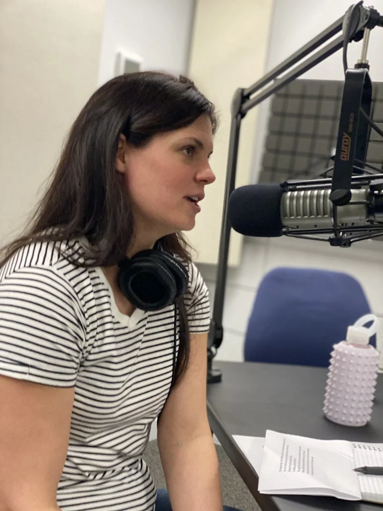 Andrea Dunlop, host of Nobody Should Believe Me behind the mic at Larj Media podcast studio, Seattle.