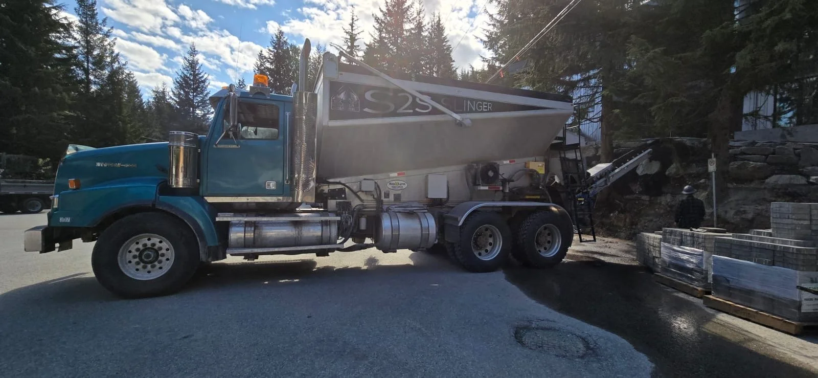 Gravel being placed with precision using slinger truck beside a road in Sea-to-Sky BC.