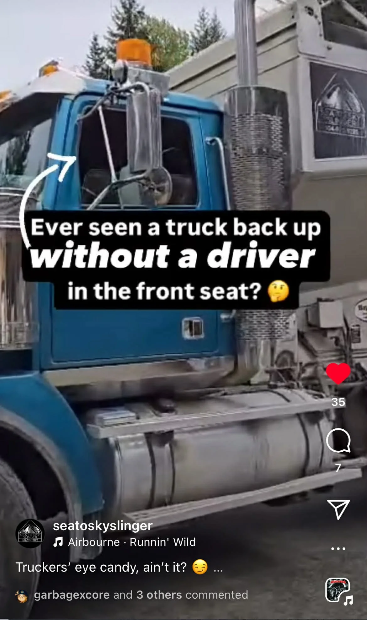 Close-up of a large blue semi-truck stone slinger with a caption questioning if trucks back up without a driver in the front seat. The video continues to display the truck operator using ground control to drive the machine.