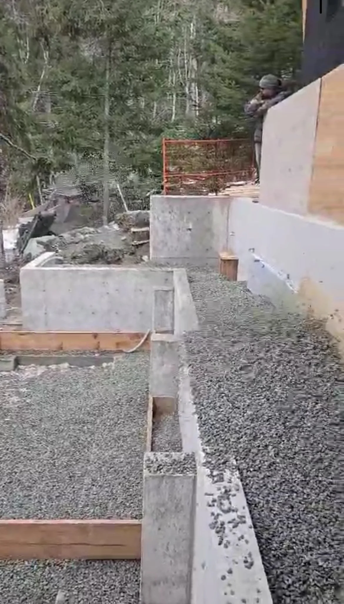 Slinger truck spreading aggregate for foundation in Pemberton