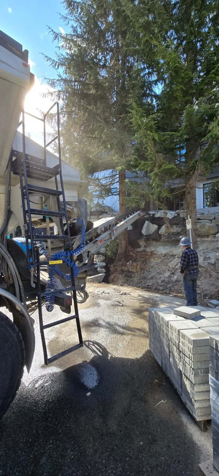 Slinger truck in action placing material on site