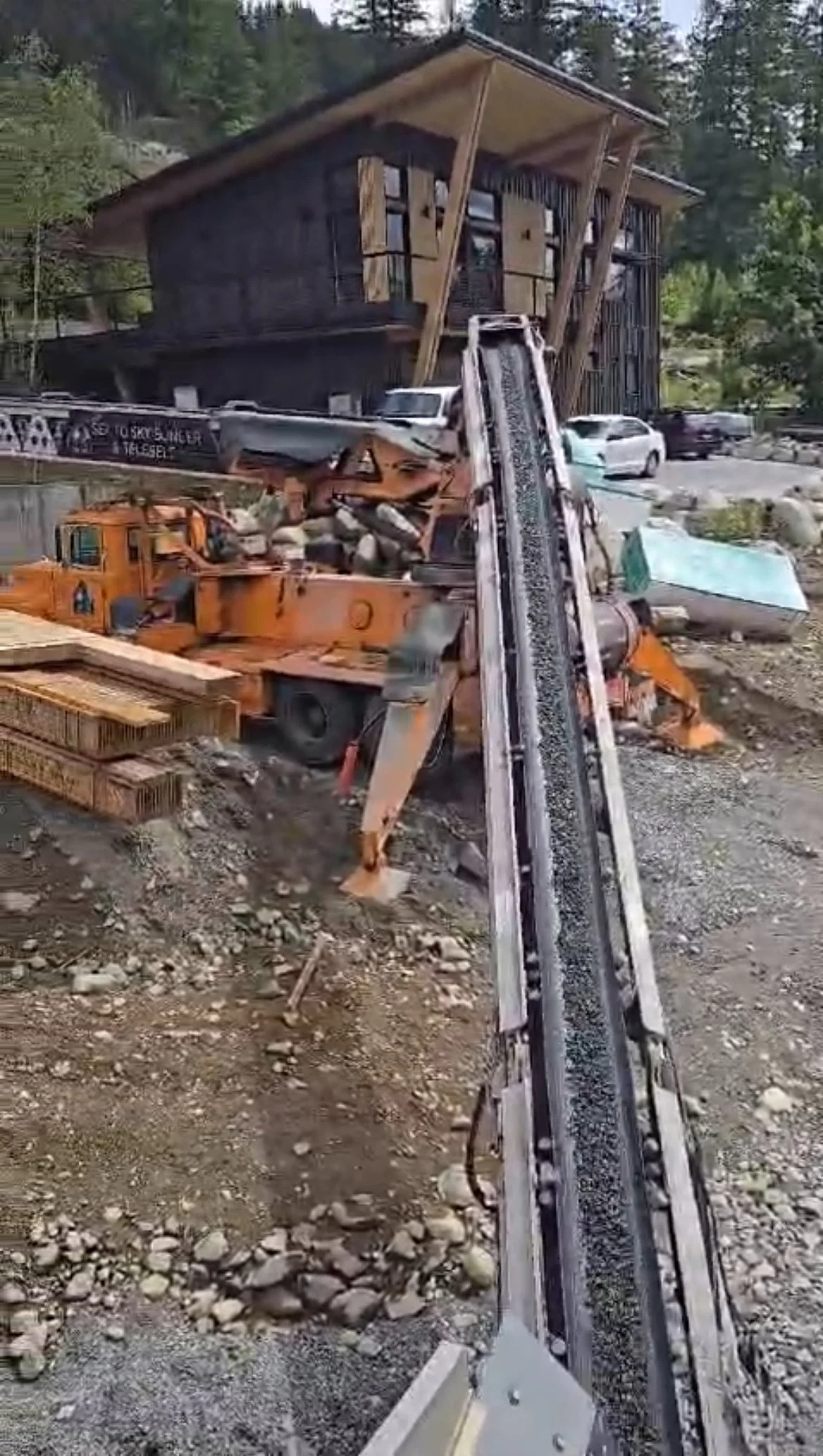 Telebelt truck delivering aggregate for backfill construction project.