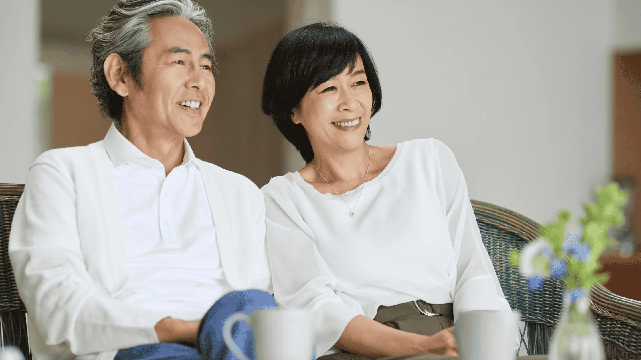 Couple sitting together in a calm, cozy space, representing connection and support.