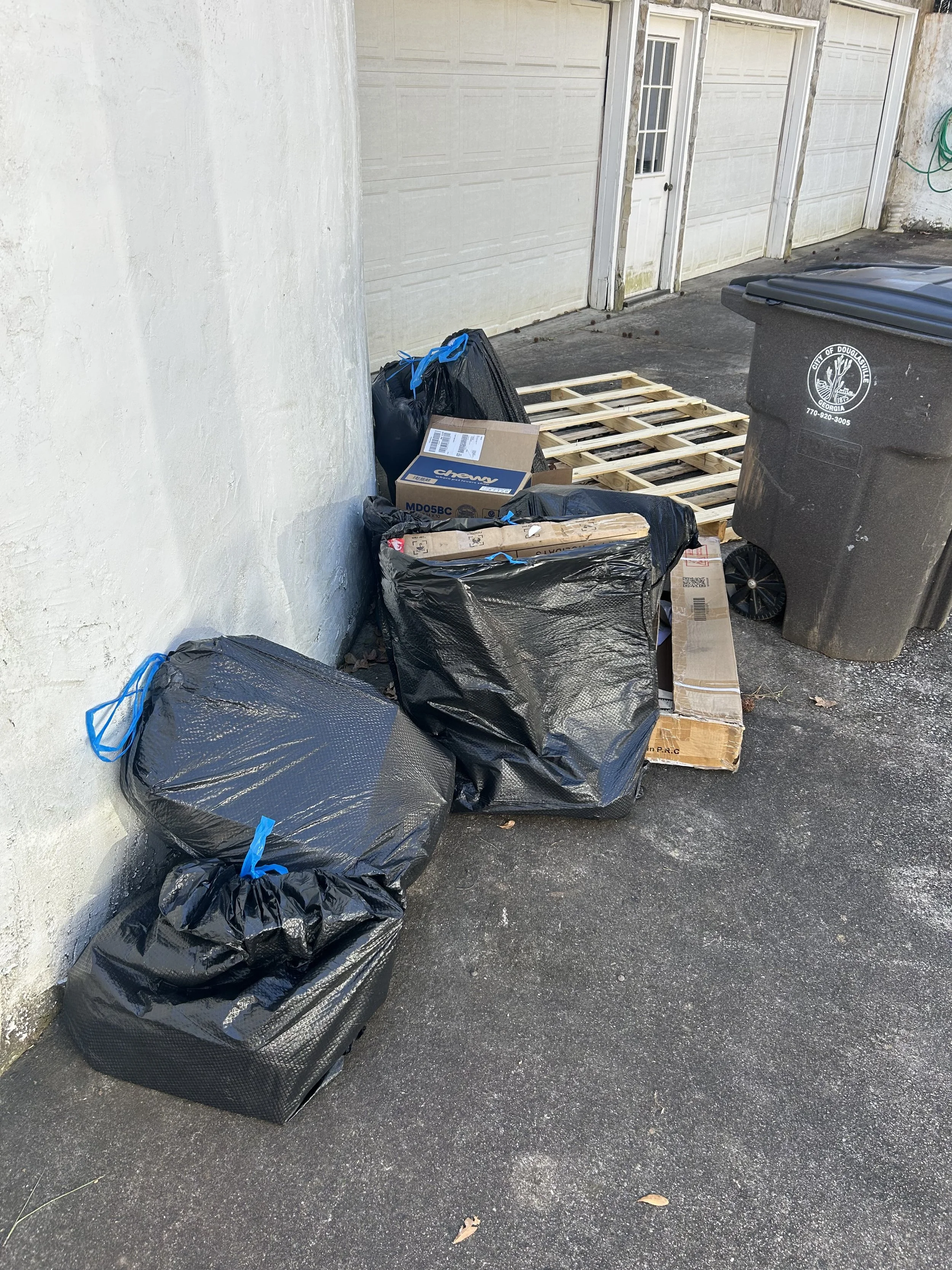 Before and after junk removal in Douglasville GA showing full property cleanout transformation