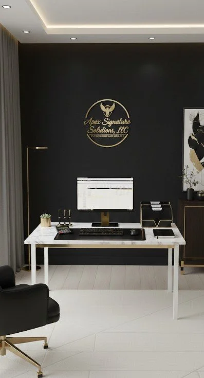 “Modern white desk with black and gold accents in a professional office, featuring the Apex Signature Solutions, LLC logo in gold on a black wall behind the workspace.”