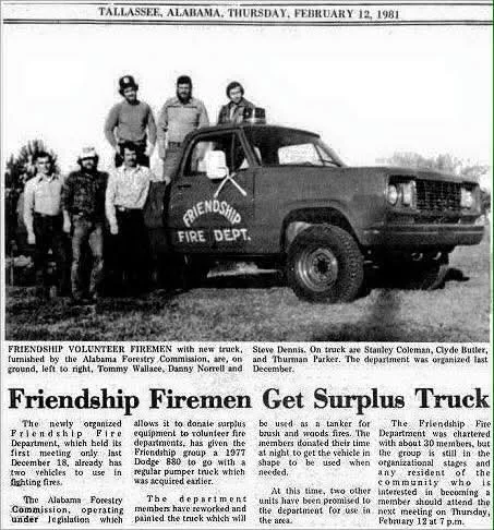 Group of six men and women standing beside a black Friendship Fire Department truck in Tallassee, Alabama, on February 12, 1981.