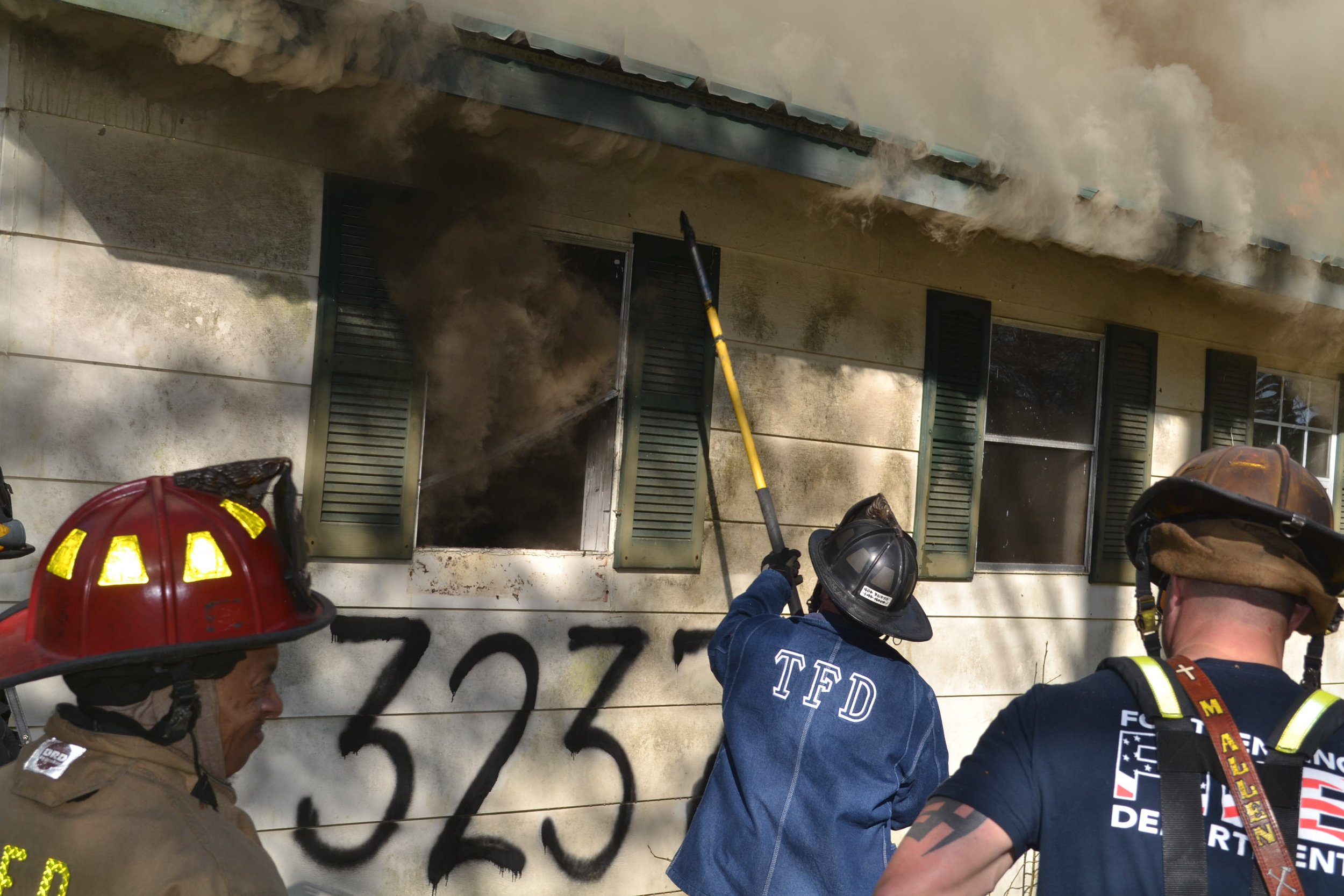 Firefighter Jake Hill demonstrating how to properly clear a window