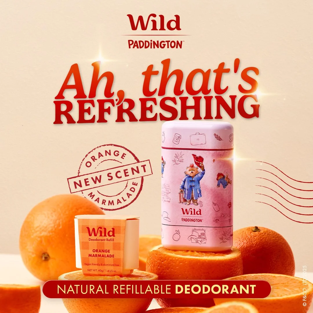 Packaging for Wild Paddington orange marmalade deodorant with an illustration of Paddington Bear on a pink container, surrounded by whole and sliced oranges, with promotional text about the scent and deodorant.