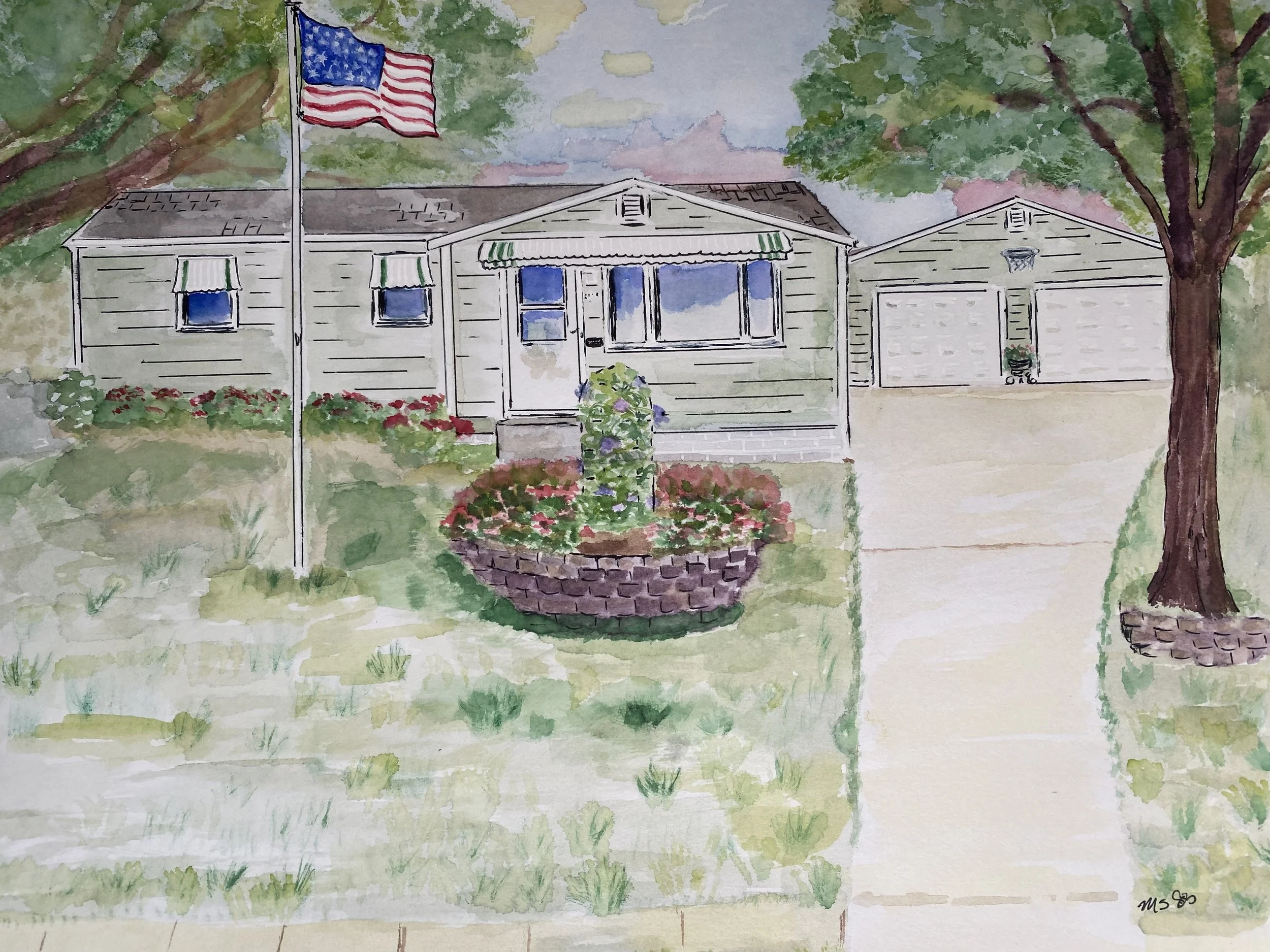 Watercolor painting of a suburban house with a American flag flying on a flagpole in front. The house has beige siding, a front door with sidelights, and windows with awnings. There are two trees with green foliage and a flower bed with red and purple flowers. The sky is partly cloudy with pinkish clouds.