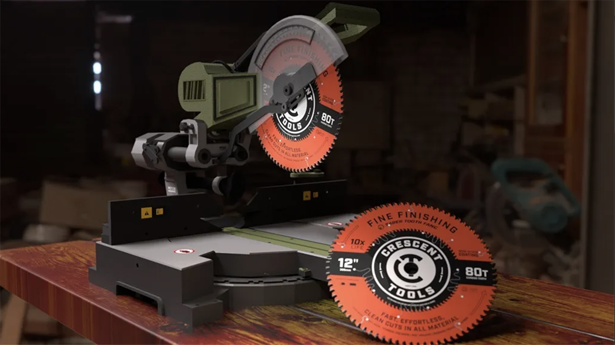 A power miter saw with a circular blade, placed on a wooden workbench in a workshop. The blade has markings for 80 teeth and 12 inches diameter.