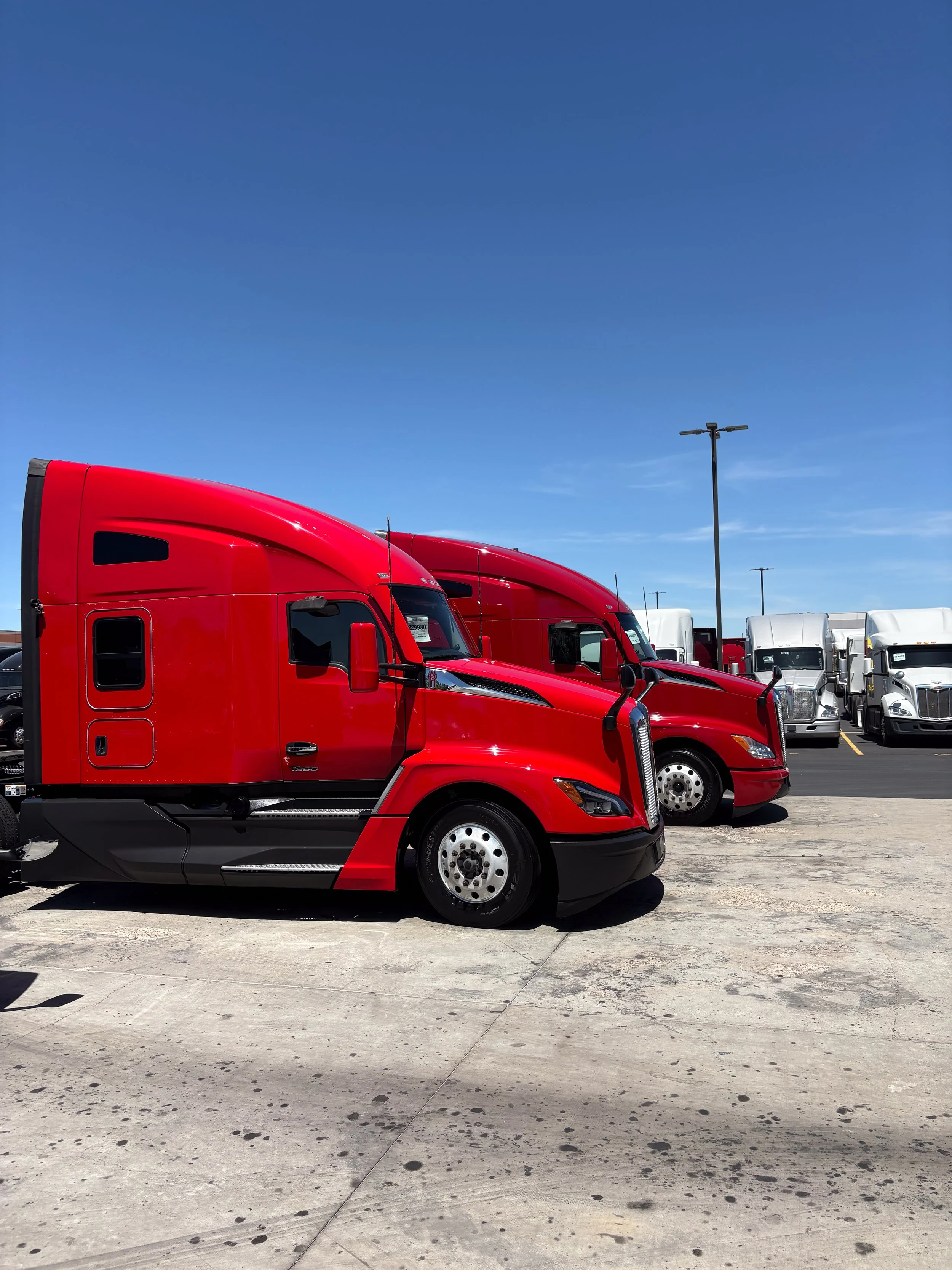 60-red-kenworth-t680-pair-dealer-lot.jpg