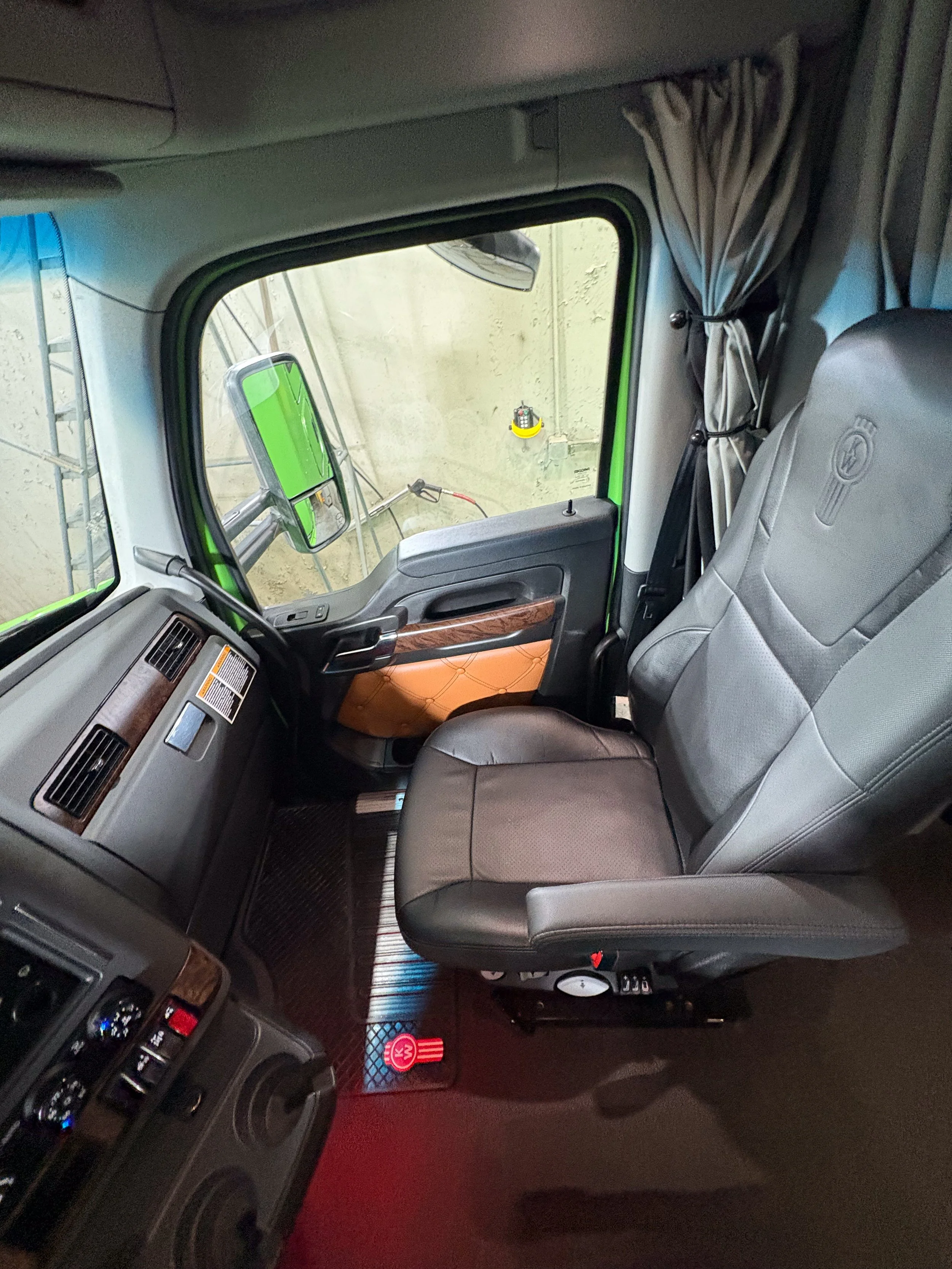 13-green-kenworth-t680-interior-driver-seat.jpg