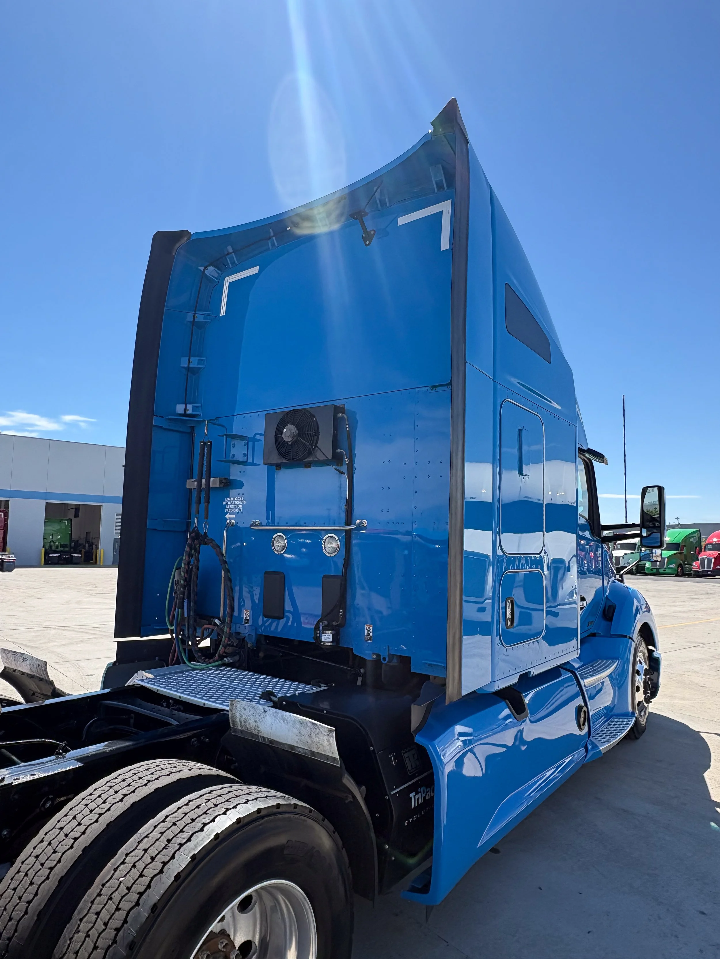 67-blue-kenworth-t680-rear-3q-after.jpg