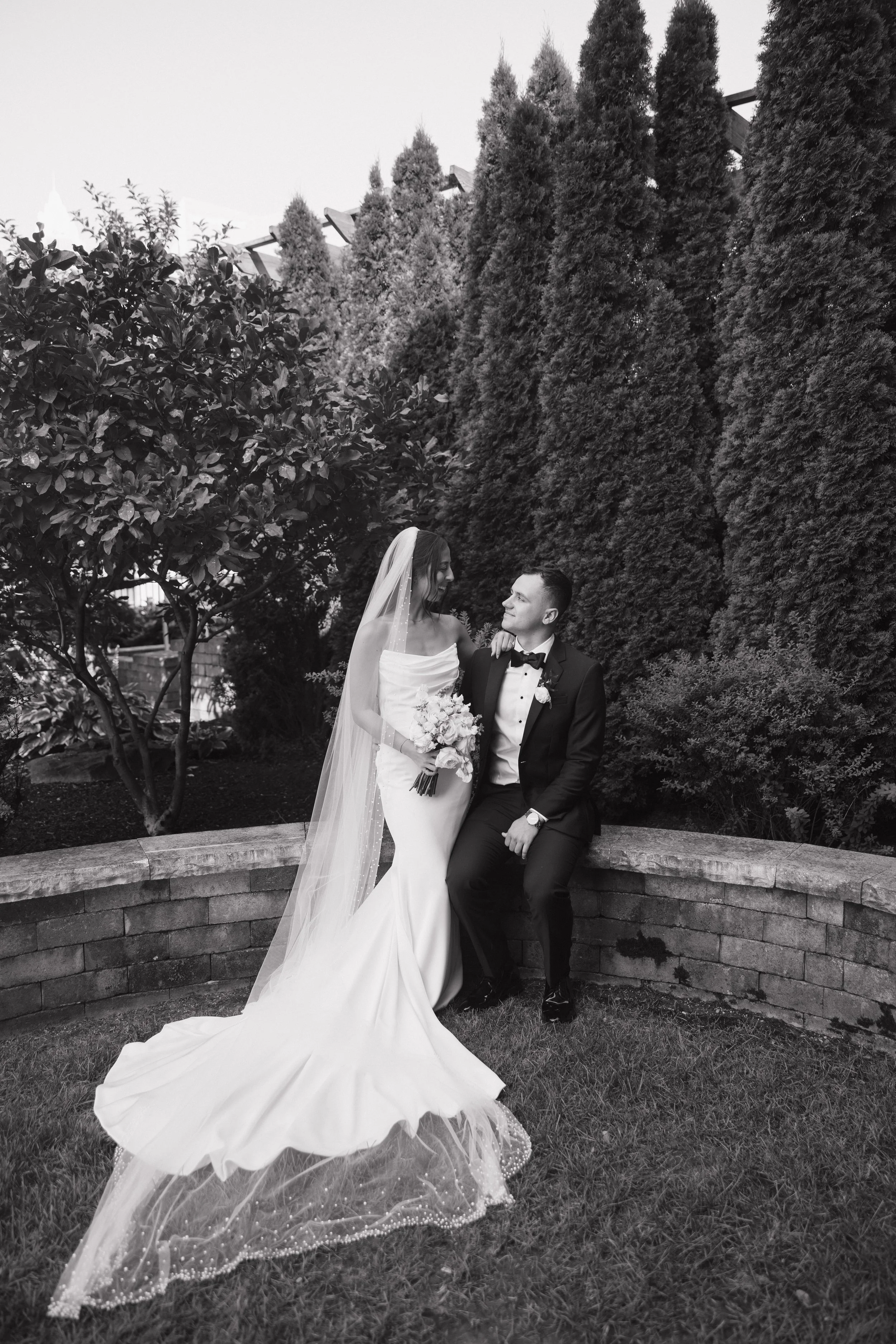 A bride and groom stealing a quiet moment together in a garden, lost in each other, the kind of romantic, unhurried wedding day memory Palm Events & Rentals helps create for every couple.