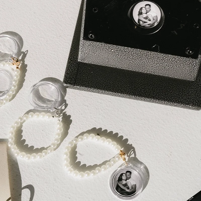 Pearl earrings with personalized photo charms and a keepsake gift box featuring a couples portrait, the kind of meaningful, curated gift Palm Events & Rentals sources and procures for weddings and special events.