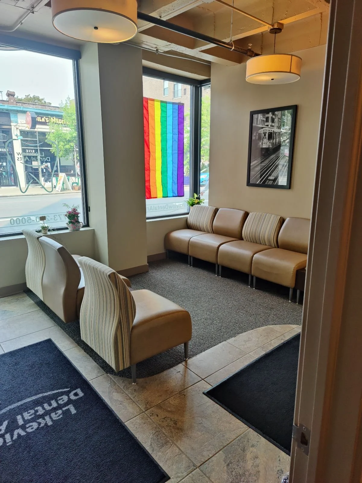 A cozy waiting area with beige leather chairs and striped armchairs.