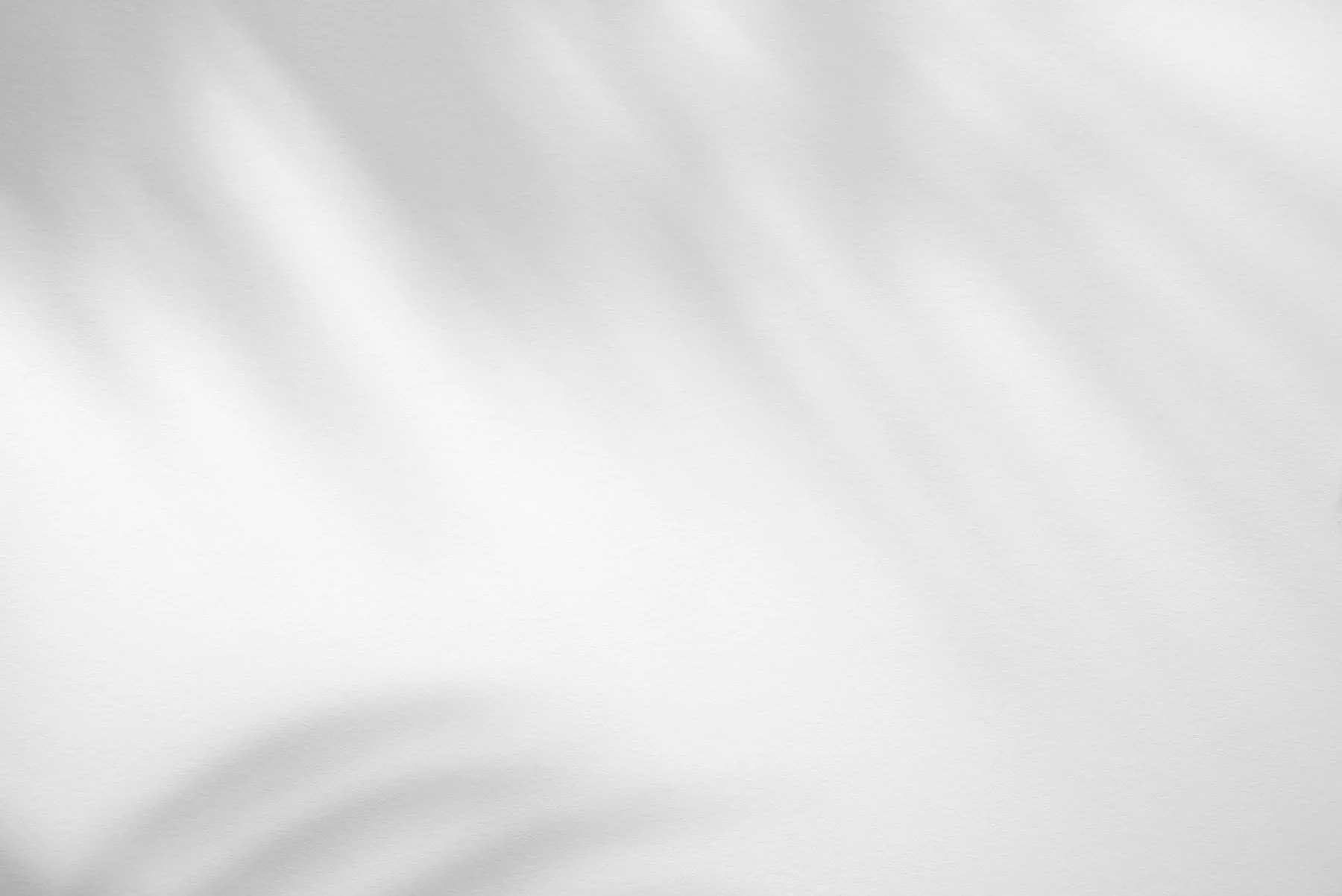 Empty white sheet of paper with slight shadows and texture.